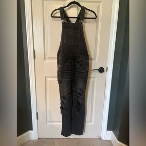 American Eagle distressed black denim overalls. Women’s M with snap closure.